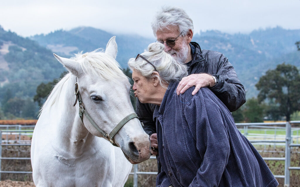 A couple enjoy time with the horses during a Connected Horse workshop at Sunrise Horse Rescue.